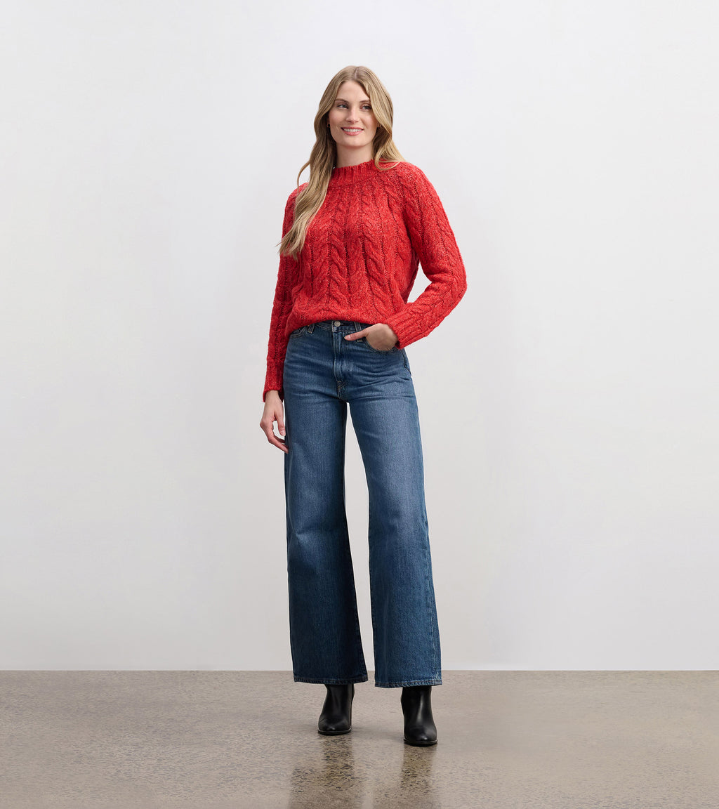 Festive red cable knit sweater with mock neckline and relaxed fit