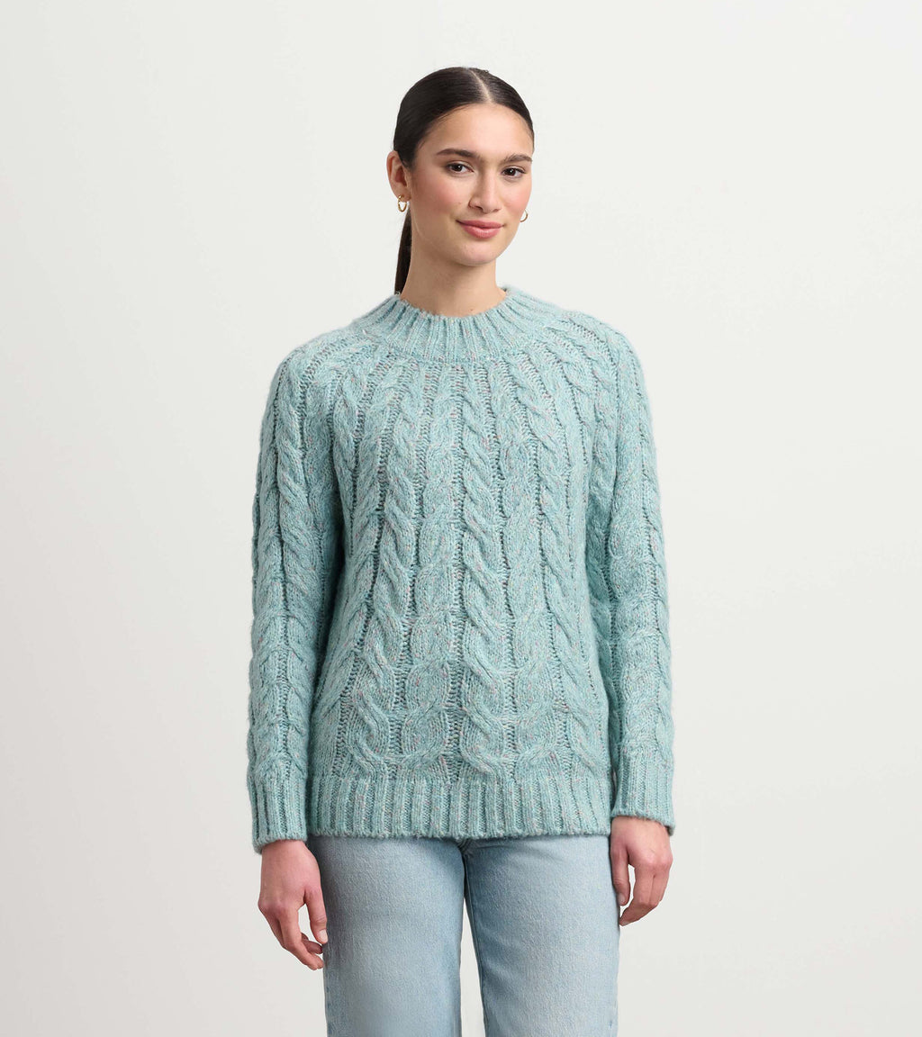 Soft turquoise cable knit sweater with mock neckline and relaxed fit