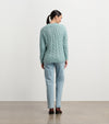 Model wearing Dylan Cable Knit Sweater in soft turquoise with jeans
