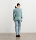 Model wearing Dylan Cable Knit Sweater in soft turquoise with jeans